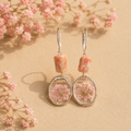 Flowers in the garden with pink opal earrings